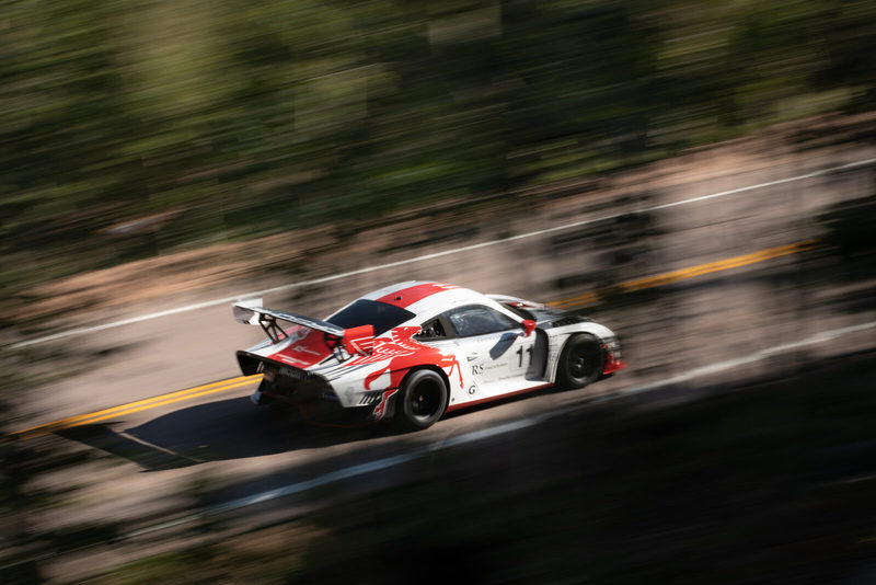 A motorsport frame marked Social-Ready: crisp car with streaked background from a pan